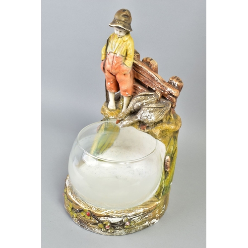 222A - A 1920'S/30'S GLASS FISH BOWL ON FIGURAL PLASTER STAND, modelled as a bare footed young boy with fis... 