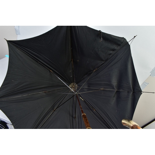 227A - A LATE VICTORIAN BLACK SILK UMBRELLA, the cane handle with a 18ct gold plated mounts, length 89cm