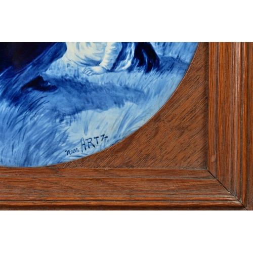 228A - AN EARLY 20TH CENTURY CIRCULAR DELFT PLAQUE IN AN OAK FRAME, the plaque signed 'Near Artz' painted w... 