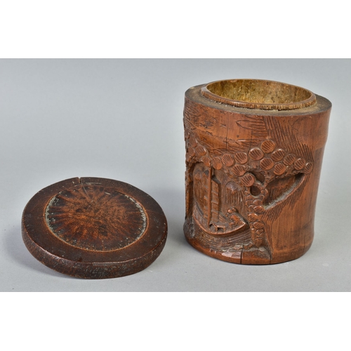 230A - AN EARLY 20TH CENTURY CHINESE BAMBOO BRUSH POT, carved with a man in a boat with overhanging trees, ... 