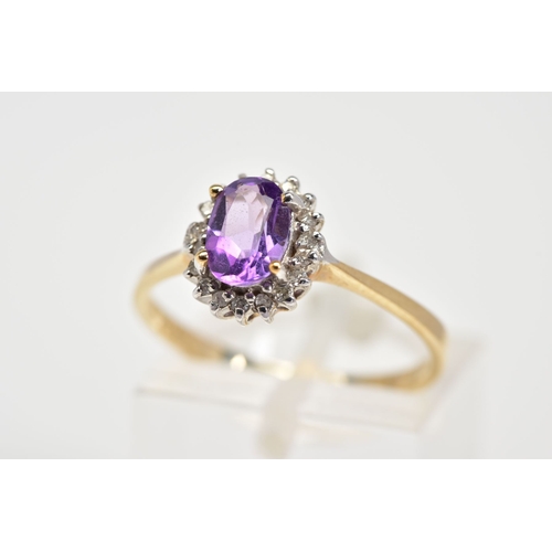 15 - A 9CT GOLD CLUSTER RING, designed with a central oval cut amethyst and single cut diamond surround, ... 