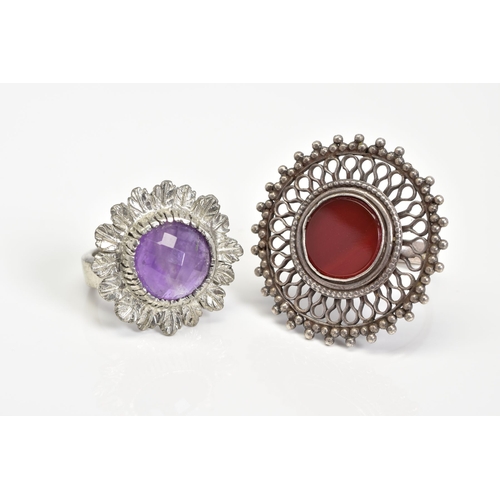 16 - TWO WHITE METAL RINGS, the first of circular design set with a central carnelian panel with an open ... 