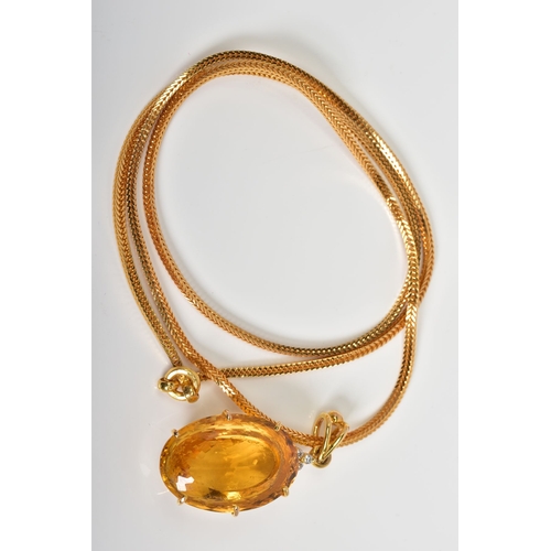 35 - A LARGE CITRINE AND DIAMOND PENDANT AND CHAIN, oval mixed cut citrine stone measuring approximately ... 