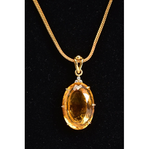 35 - A LARGE CITRINE AND DIAMOND PENDANT AND CHAIN, oval mixed cut citrine stone measuring approximately ... 