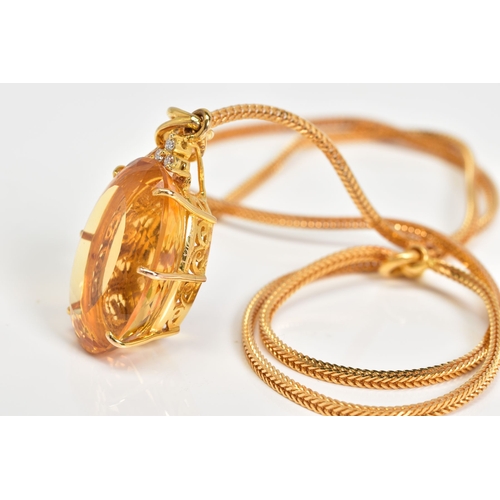 35 - A LARGE CITRINE AND DIAMOND PENDANT AND CHAIN, oval mixed cut citrine stone measuring approximately ... 