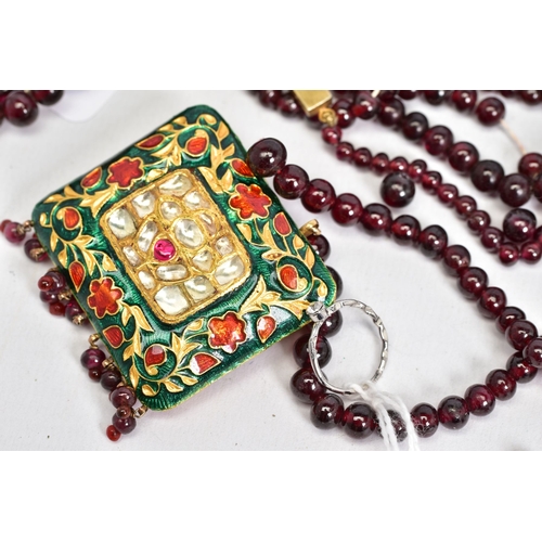 37 - FOUR JEWELLERY ITEMS, to include a Rajasthani enamelled pendant strung to a garnet bead necklace, a ... 