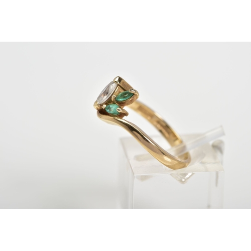 49 - A 9CT GOLD THREE STONE RING, designed with a marquise cut cubic zirconia with two marquise cut emera... 