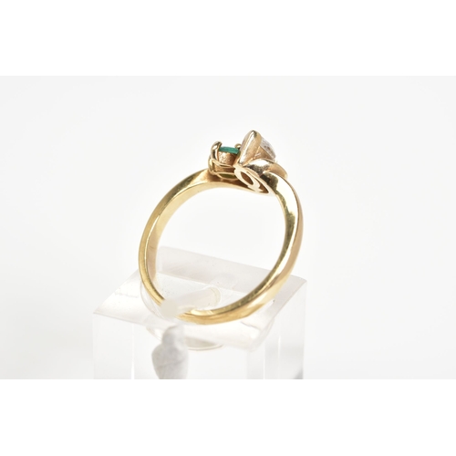 49 - A 9CT GOLD THREE STONE RING, designed with a marquise cut cubic zirconia with two marquise cut emera... 