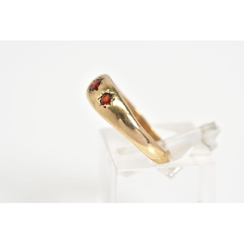 51 - A 9CT GOLD THREE STONE RING, set with three graduated circular cut garnets within a plain polished b... 