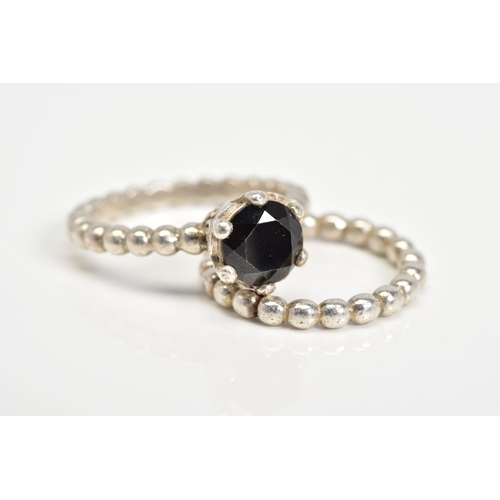 54 - TWO PANDORA RINGS, the first set with a circular cut onyx within a six claw setting, with scrolling ... 