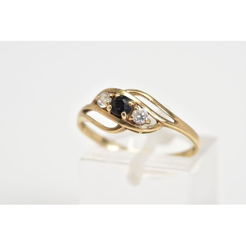 56 - AN EARLY 20TH CENTURY 9CT GOLD RING, of open work design set with a diagonal row of a central circul... 