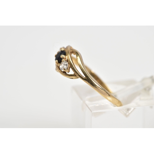 56 - AN EARLY 20TH CENTURY 9CT GOLD RING, of open work design set with a diagonal row of a central circul... 