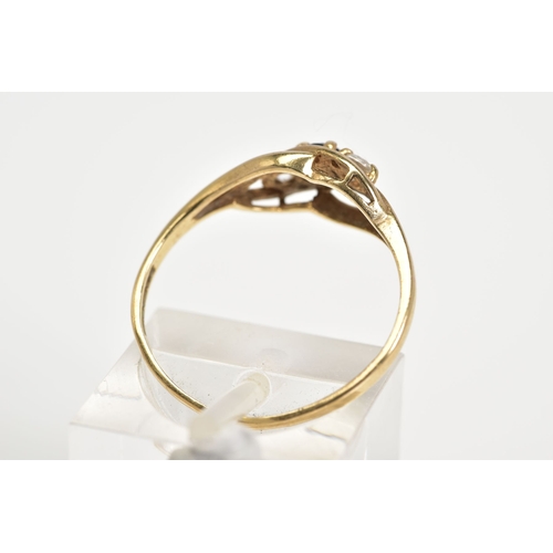 56 - AN EARLY 20TH CENTURY 9CT GOLD RING, of open work design set with a diagonal row of a central circul... 