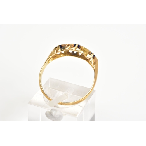 57 - AN EARLY 20TH CENTURY BOAT RING, set with three graduated oval cut, assessed as synthetic sapphire, ... 