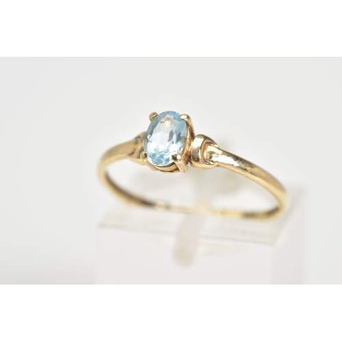 60 - A SINGLE STONE RING, set with a central oval cut aquamarine within a four claw setting, to the plain... 