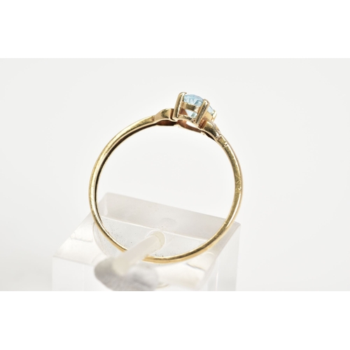 60 - A SINGLE STONE RING, set with a central oval cut aquamarine within a four claw setting, to the plain... 