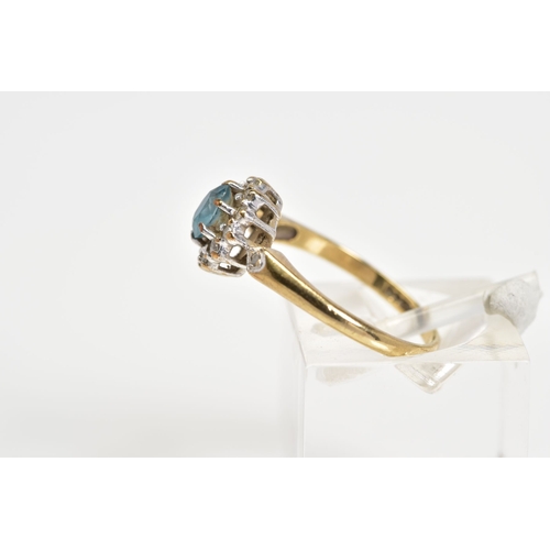 66 - A 9CT GOLD CLUSTER RING, designed with a central oval cut blue topaz and single cut diamond surround... 