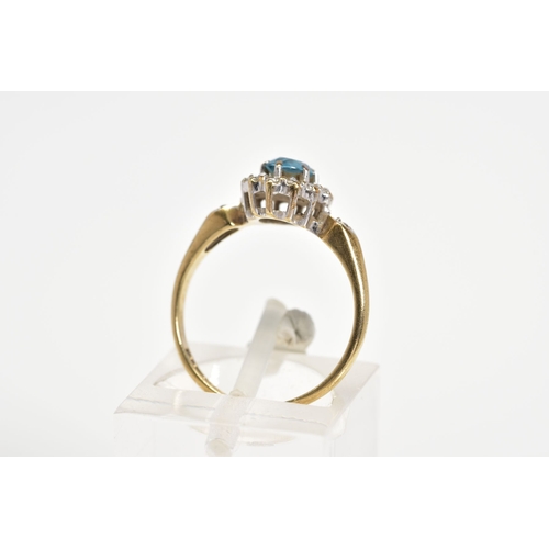 66 - A 9CT GOLD CLUSTER RING, designed with a central oval cut blue topaz and single cut diamond surround... 