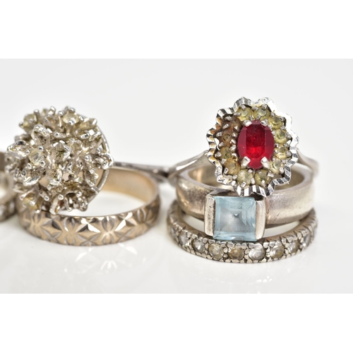 79 - A SELECTION OF WHITE METAL RINGS, to include three coloured stone set cluster rings, two colourless ... 