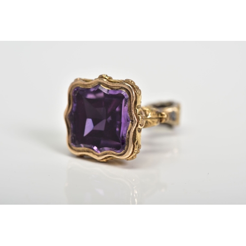 85 - A 9CT GOLD FOB SEAL, with a scrolling design handle set with an amethyst, height 25mm, approximate w... 