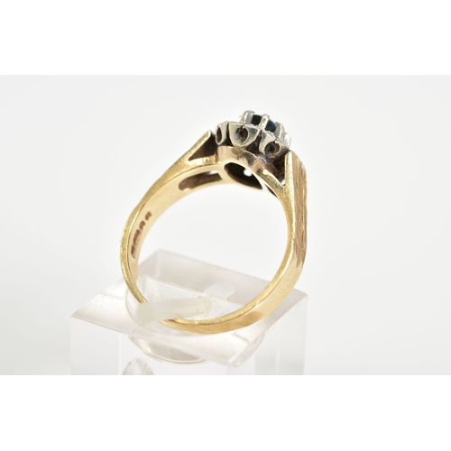 88 - A 9CT GOLD CLUSTER RING, designed with a central; oval cut sapphire within an eight claw setting and... 