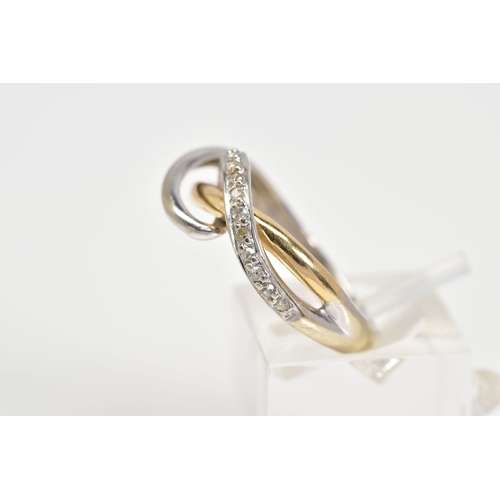 91 - A DIAMOND SET CROSSOVER RING, of white and yellow metal open work crossover style, set with a diagon... 