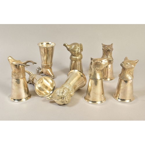 104 - A MATCHED SET OF EIGHT SILVER PLATE/PEWTER STIRRUP CUPS, cast with animal mask or bird finials, incl... 