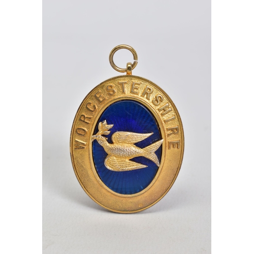 175 - A SILVER GILT MEDALLION, of oval shape featuring a blue enamel centre with bird embellishment and Wo... 