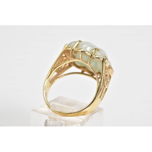 1 - A 14CT GOLD JADE RING, a carved jade panel set within a four claw setting, with Oriental design open... 