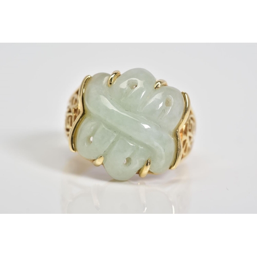 1 - A 14CT GOLD JADE RING, a carved jade panel set within a four claw setting, with Oriental design open... 