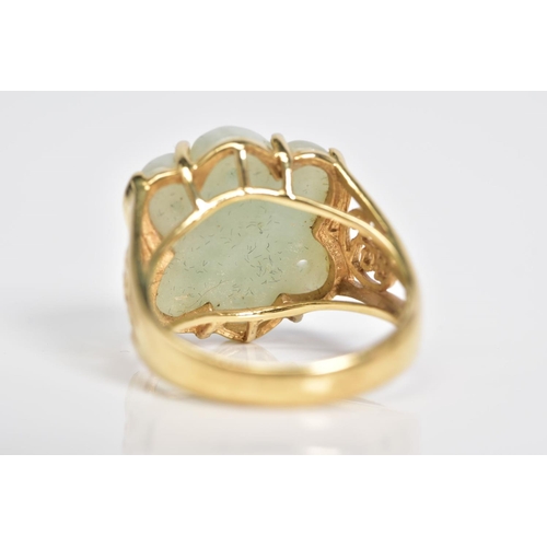 1 - A 14CT GOLD JADE RING, a carved jade panel set within a four claw setting, with Oriental design open... 