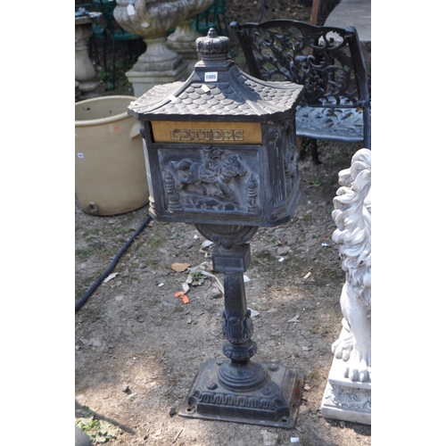 1005 - A MODERN CAST IRON POST BOX, with Chinese pagoda style roof, horse and rider detail to casting on th... 