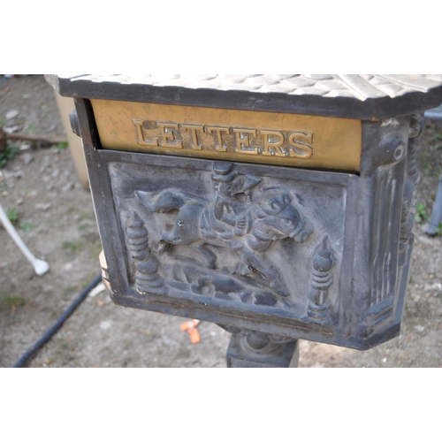 1005 - A MODERN CAST IRON POST BOX, with Chinese pagoda style roof, horse and rider detail to casting on th... 