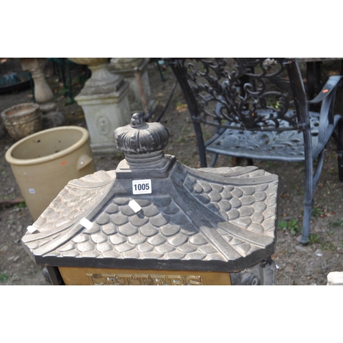 1005 - A MODERN CAST IRON POST BOX, with Chinese pagoda style roof, horse and rider detail to casting on th... 