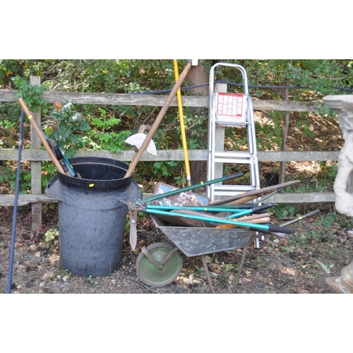 1008 - A COLLECTION OF VINTAGE GARDEN TOOLS, including a plastic dustbin, a wheelbarrow, rakes, spades, for... 