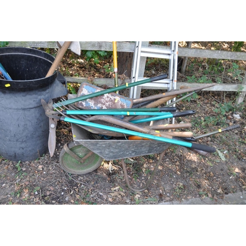 1008 - A COLLECTION OF VINTAGE GARDEN TOOLS, including a plastic dustbin, a wheelbarrow, rakes, spades, for... 