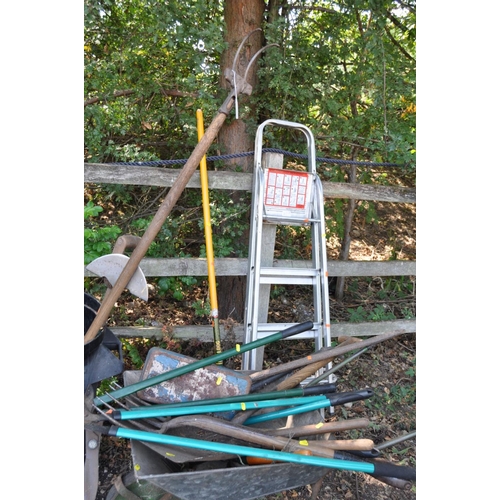 1008 - A COLLECTION OF VINTAGE GARDEN TOOLS, including a plastic dustbin, a wheelbarrow, rakes, spades, for... 