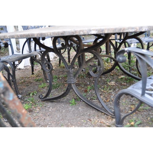 1011 - A LARGE STONE EFFECT GARDEN TABLE AND EIGHT CHAIRS, with real stone veneers in a crazy paving effect... 