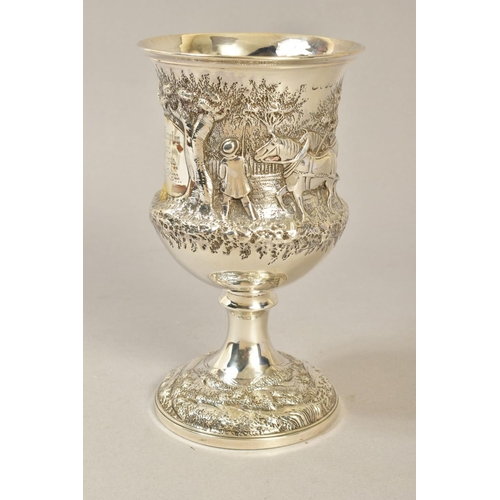 105 - A VICTORIAN SILVER CUP, repousse decorated with a rural scene of two men and horses ploughing, engra... 