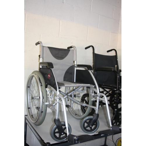 1124 - TWO WHEELCHAIRS, both with footrests, one is a Enigma with a silver finish and a standard 4cm wide s... 