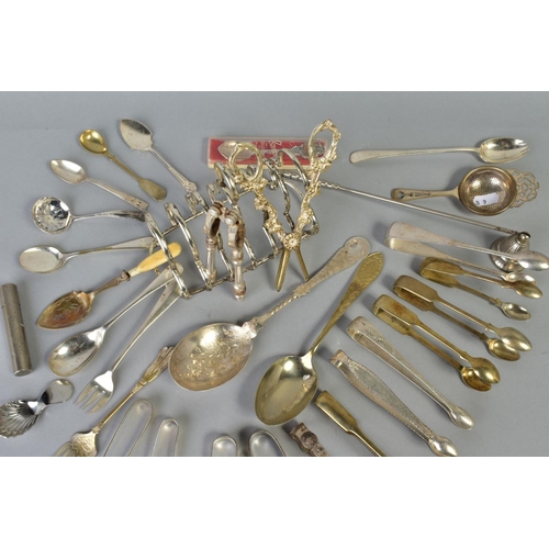 113 - A SELECTION OF WHITE METAL CULTERY, to include a pair of George lll silver engraved sugar tongs, a p... 