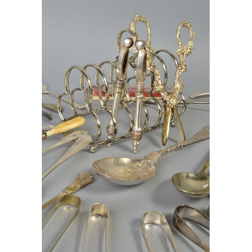 113 - A SELECTION OF WHITE METAL CULTERY, to include a pair of George lll silver engraved sugar tongs, a p... 