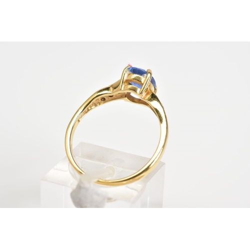 12 - AN 18CT GOLD SAPPHIRE AND DIAMOND RING, designed with a central oval cut sapphire with round brillia... 