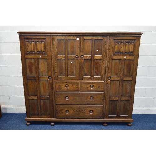 1202 - AN EARLY TO MID 20TH CENTURY LOW SOLID OAK COMPACTUM WARDROBE, comprising two panelled doors with li... 