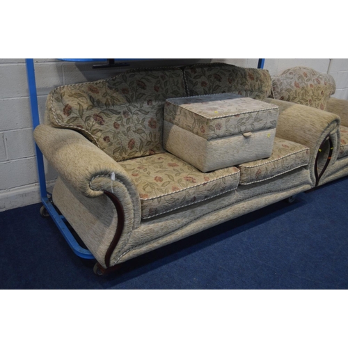 1203 - A CREAM AND FLORAL UPHOLSTERED FOUR PIECE LOUNGE SUITE, comprising a three and a two seater settee, ... 