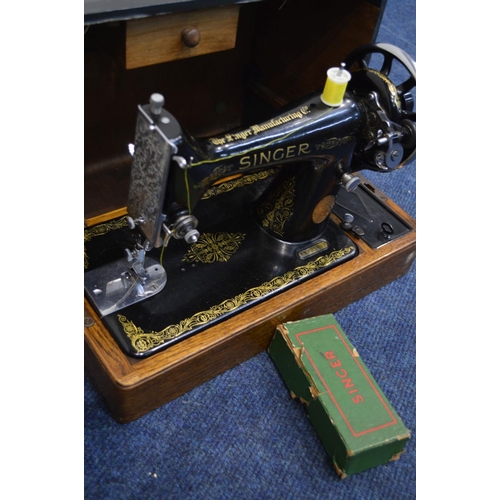 1209 - A WALNUT CASED SINGER SEWING MACHINE, and another Singer sewing machine, together with a brass foldi... 