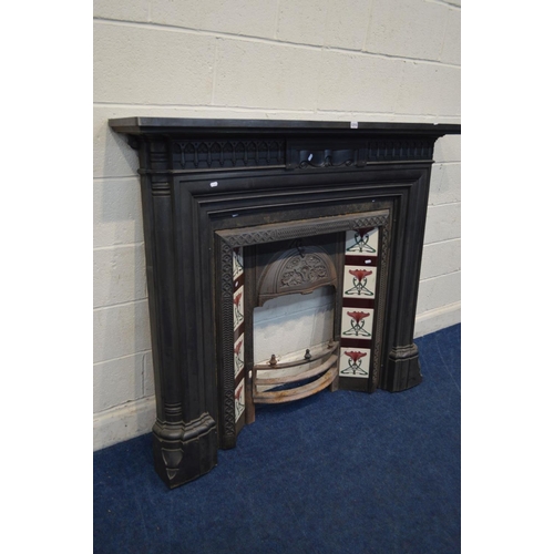 1215 - A VICTORIAN STYLE CAST IRON FIRE SURROUND and insert with Art Nouveau burgundy, green and white grou... 