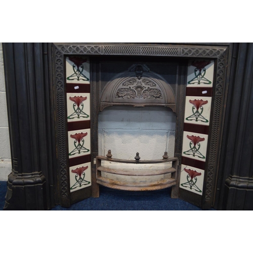 1215 - A VICTORIAN STYLE CAST IRON FIRE SURROUND and insert with Art Nouveau burgundy, green and white grou... 