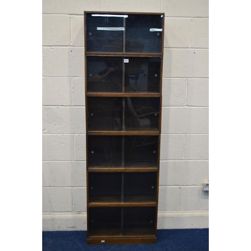 1217 - AN EARLY TO MID 20TH CENTURY UNIX OAK MODULAR SIX SECTION SHELVING UNIT with double sliding glass fr... 