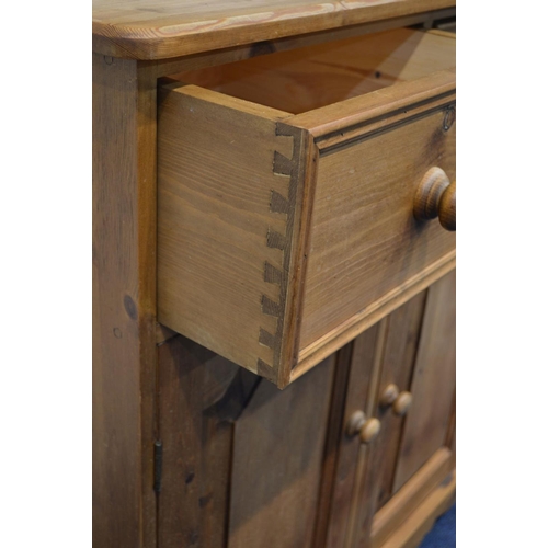 1218 - A MODERN PINE KITCHEN DRESSER, to top section with double glazed cupboard doors above a base with th... 